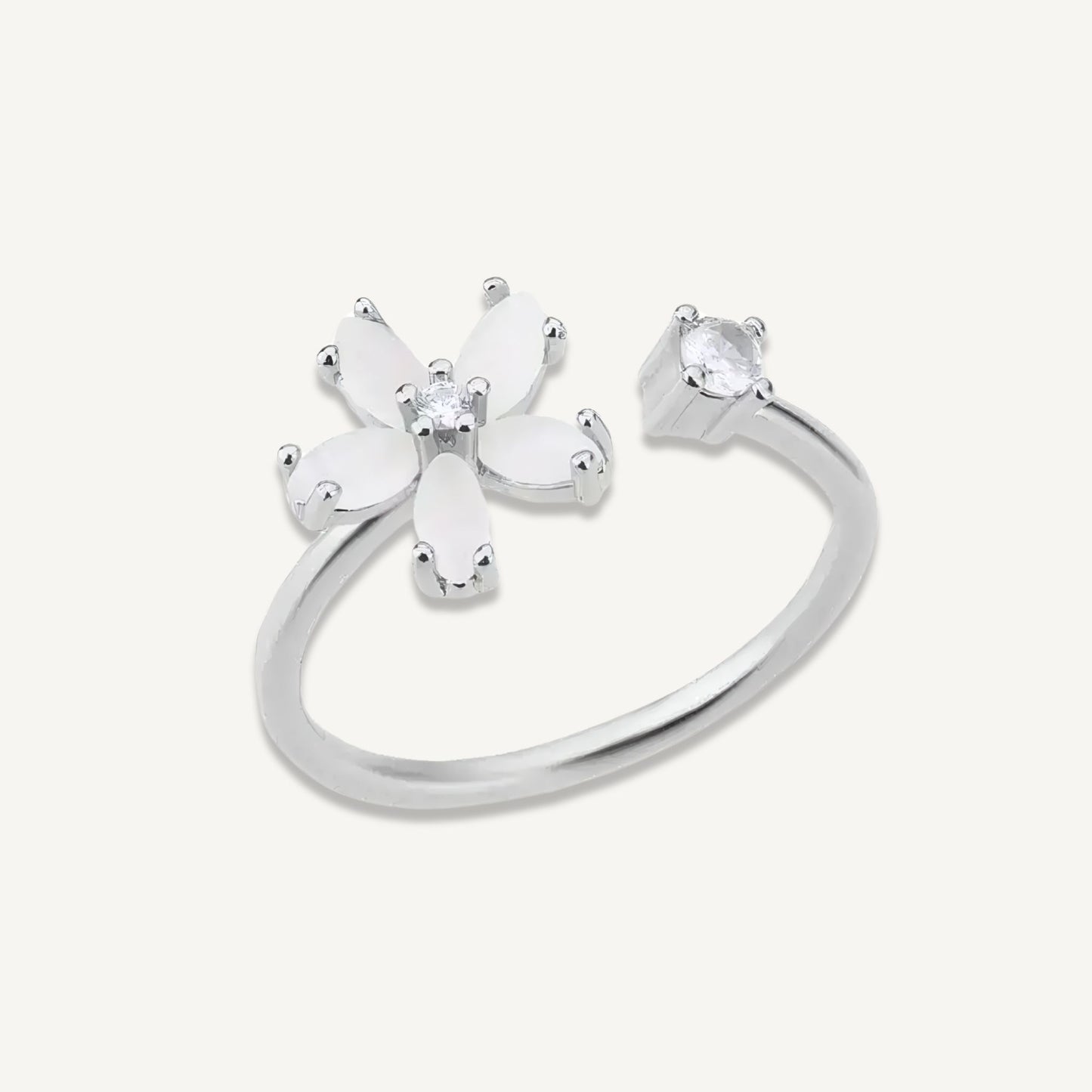 Delphine Ring in silver-tone stainless steel with opal-effect flower and CZ accent, displayed on white.